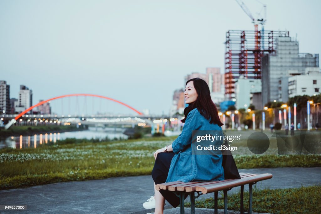 Beautiful young woman relaxing and enjoying the city view over the sky garden