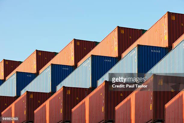 stacks of shipping containers - transport fotografías e imágenes de stock