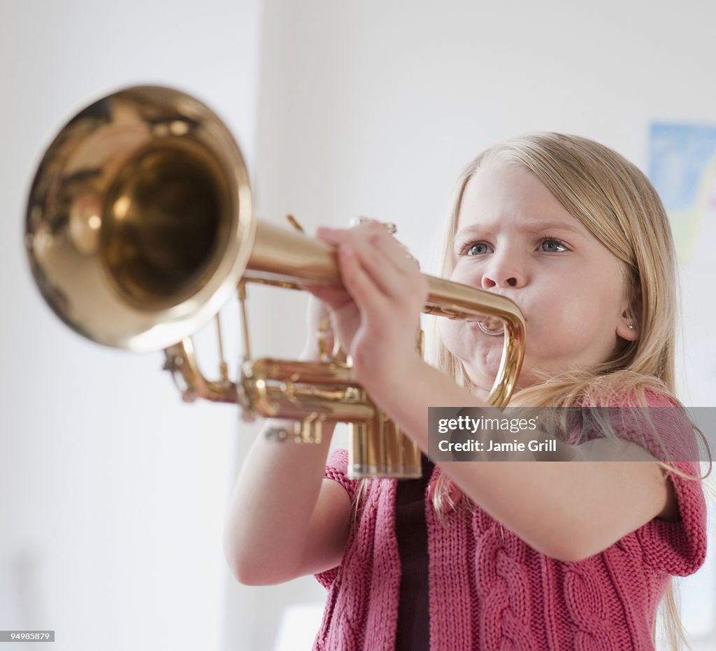 Young girl playing the trumpet