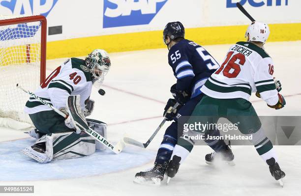 Devan Dubnyk of the Minnesota Wild makes a save off Mark Scheifele of the Winnipeg Jets in Game Five of the Western Conference First Round during the...