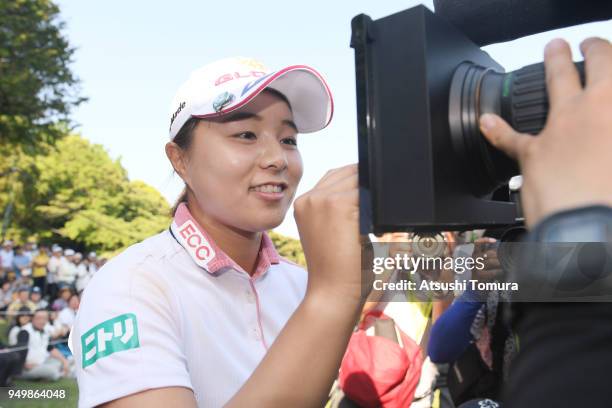 Saki Nagamine of Japan signs an autograph on the TV camera after winning the Fuji Sankei Ladies Classic at Kawana Hotel Golf Course Fuji Course on...