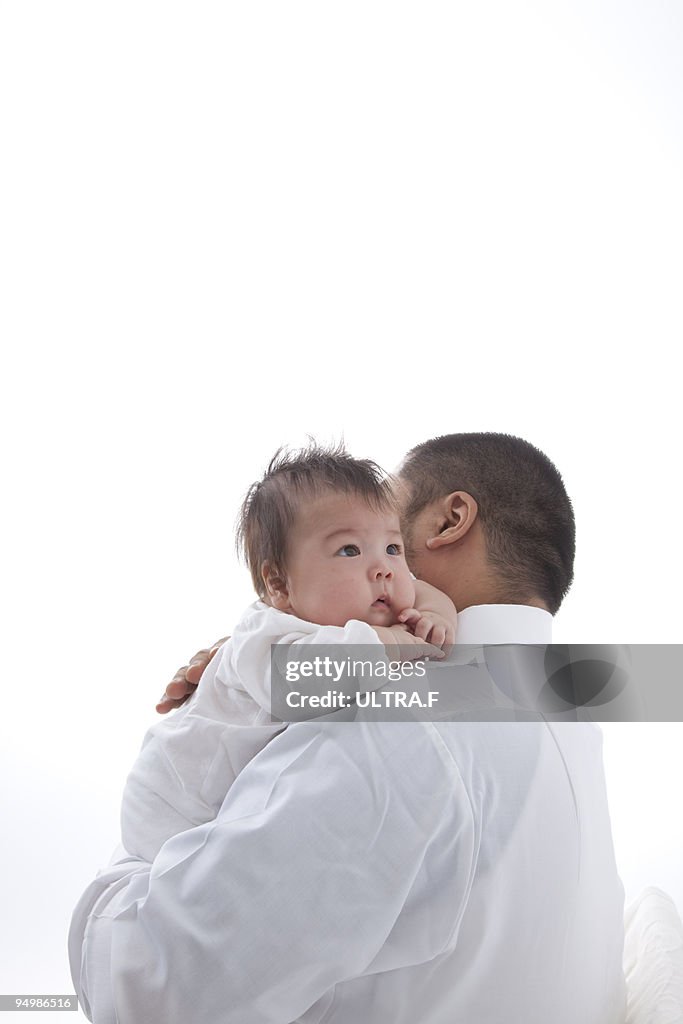 Father carrying his son.