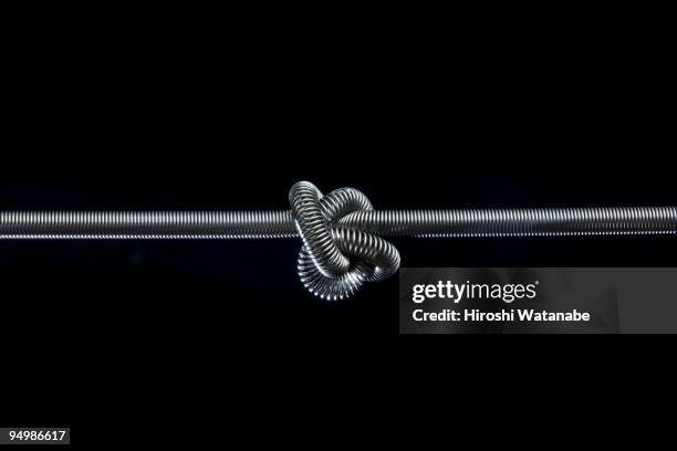 tangled steel - tied knot stock pictures, royalty-free photos & images