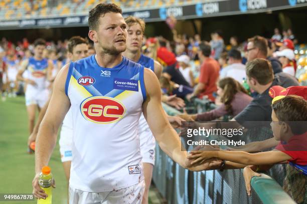 Steven May of the Suns celebrates with fans during the round five AFL match between the Brisbane Lions and the Gold Coast Suns at The Gabba on April...