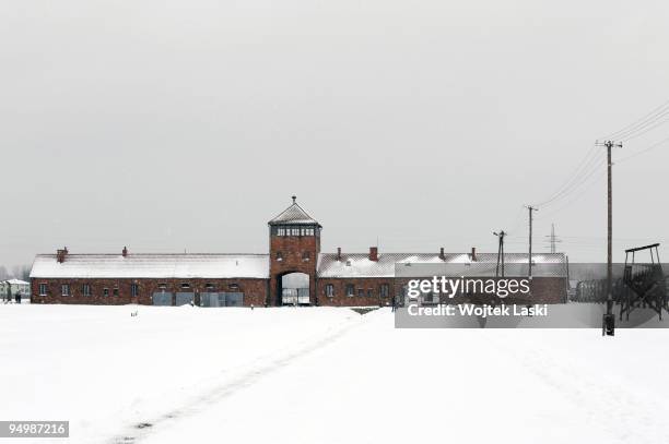 Visitors to Auschwitz Concentration Camp walk along the life barbed wire at Auschwitz II-Birkenau extermination camp on December 17, 2009 in...
