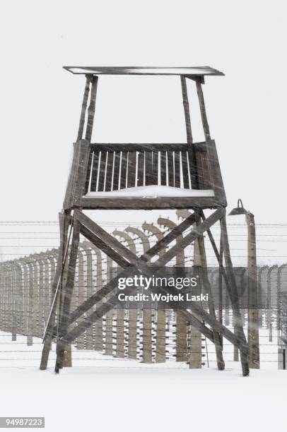 Guard tower and life barbed wire encloses the Auschwitz II-Birkenau extermination camp on December 17, 2009 in Brzezinka, Poland. Auschwitz was a...