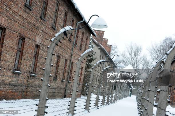 Guards road between life barbed wire fences at the Auschwitz I concentration camp on December 17, 2009 in Oswiecim, Poland. Auschwitz was a network...