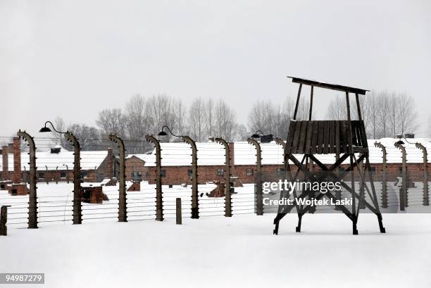 Guard tower, life barbed wire, wrecked chimneys and barracks of the former Auschwitz II-Birkenau extermination camp on December 17, 2009 in...