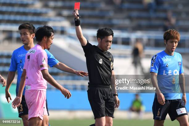 Kazunori Kan of Tochigi SC is shown a red card by referee Hirokazu Otsubo during the J.League J2 match between Yokohama FC and Tochigi SC at Nippatsu...