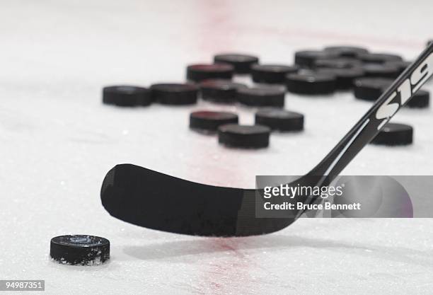 Pucks lie on the ice during warmups prior to the game between the Florida Panthers and the New Jersey Devils at the Prudential Center on December 11,...