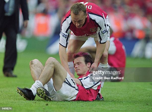 Fredrik Ljungberg of Arsenal is consoled by team mate Lee Dixon after defeat in the AXA Sponsored FA Cup Final against Liverpool at the Millennium...