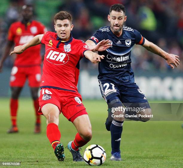 Carl Valeri of the Victory and Nathan Konstandopoulos of Adelaide United contest the ball during the A-League Elimination Final match between...
