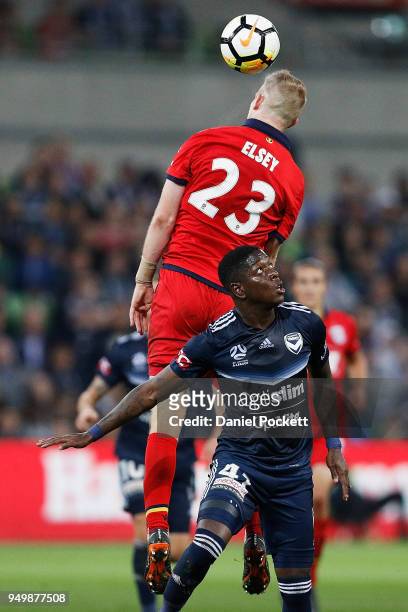 Jordan Elsey of Adelaide United and Leroy George of the Victory contest the ball during the A-League Elimination Final match between Melbourne...