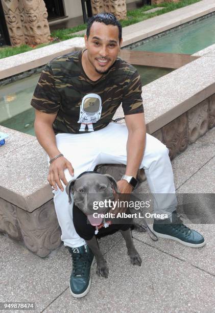 Cisco Reyes poses with Luna for Brand Bash Canine's And Cocktails To Benefit The Little Red Dog held at Sowden House on April 21, 2018 in Los...