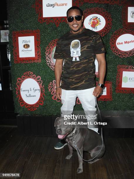 Cisco Reyes poses with Luna for Brand Bash Canine's And Cocktails To Benefit The Little Red Dog held at Sowden House on April 21, 2018 in Los...