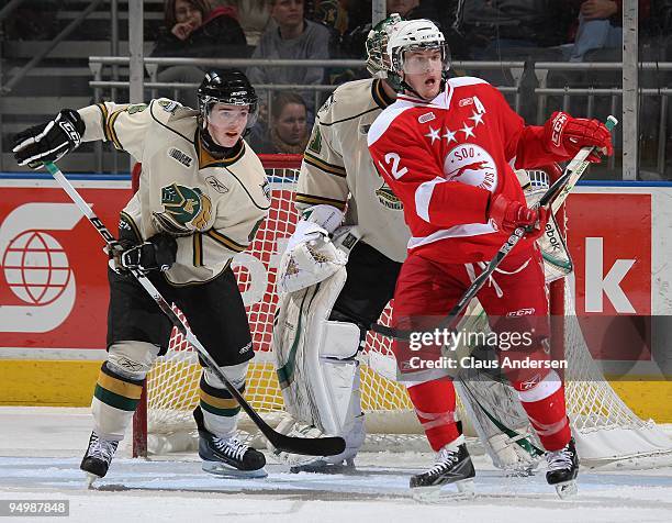 James Livingston of the Sault Ste. Marie Greyhounds battles with Scott Harrington of the London Knights in a game on December 18, 2009 at the John...