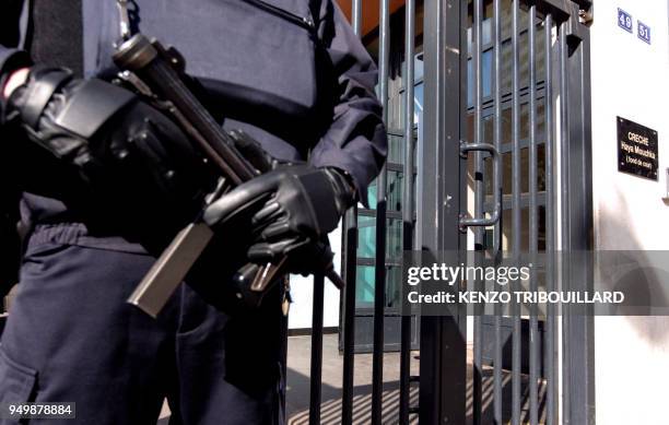 Policeman stands guard in front of a Jewish kinder garden, on March 19, 2012 in Paris, after French Interior Minister ordered security to be...