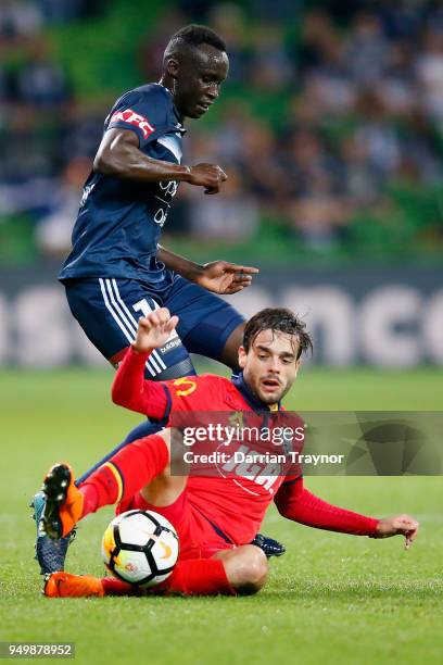 Nikola Mileusnic of Adelaide United challenges Thomas Deng of the Victory during the A-League Elimination Final match between Melbourne Victory and...