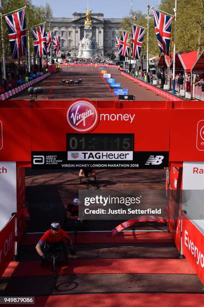 David Weir of Great Britain crosses the finish line to win the men's VMLM Wheelchair race during the Virgin Money London Marathon at United Kingdom...
