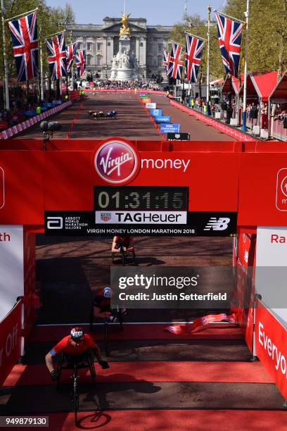 David Weir of Great Britain crosses the finish line to win the men's VMLM Wheelchair race during the Virgin Money London Marathon at United Kingdom...