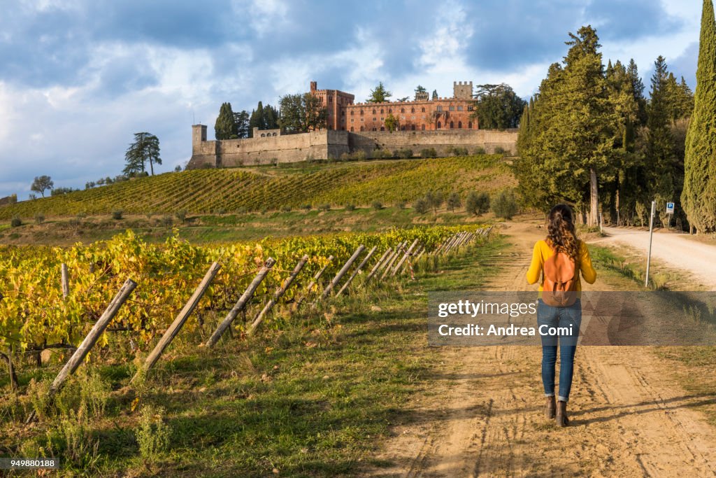 Woman walking near the Brolio castle. Radda in Chianti, Siena province, Tuscany.