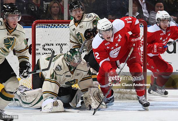James Livingston of the Sault Ste. Marie Greyhounds battles in front of Michael Hutchinson of the London Knights in a game on December 18, 2009 at...