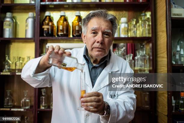 Nenan Jovanov poses for a picture in his 64 years old perfume shop in Belgrade on April 19, 2018. Nenad literally grow up in this "time capsule" shop...