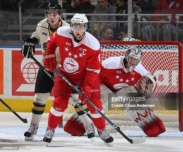 Jacob Muzzin of the Sault Ste. Marie Greyhounds defends in front of teammate Bryce O'Hagen with Leigh Salters of the London Knights standing in...
