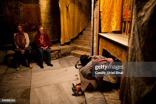 Christian pilgrim kneels at the spot in the Grotto of the Church of the Nativity where according to tradition Jesus was born on December 21, 2009 in...