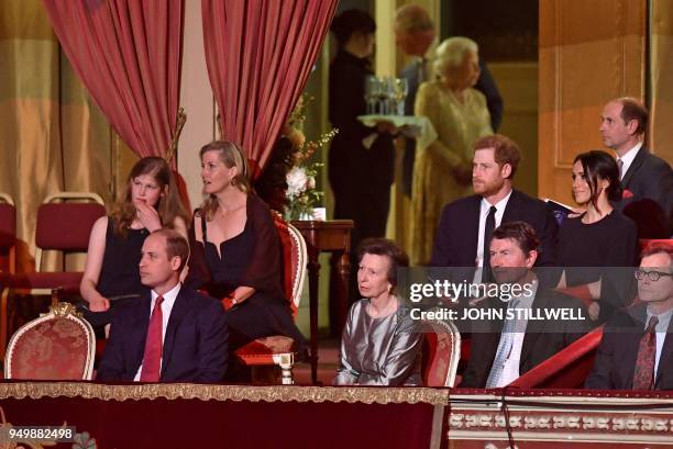 Britain's Queen Elizabeth II and her son Britain's Prince Charles, Prince of Wales stand in the background as other members of the Royal family,...