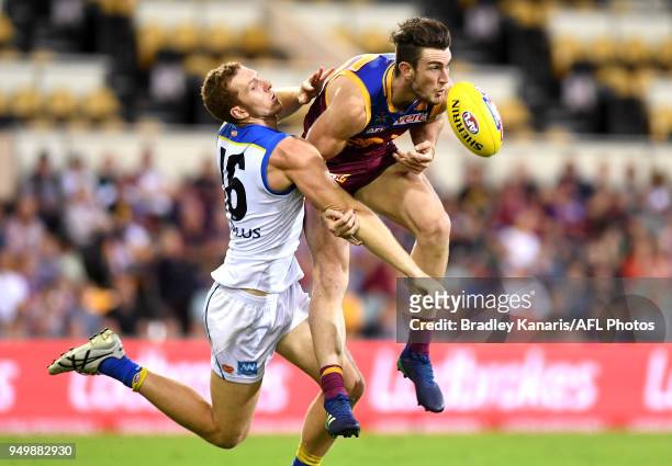 Daniel McStay of the Lions is challenged by Rory Thompson of the Suns during the round five AFL match between the Brisbane Lions and the Gold Coast...