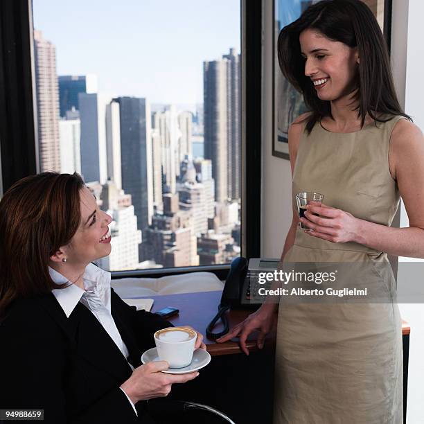 women having coffee in the office - alberto guglielmi stock pictures, royalty-free photos & images