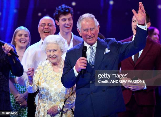 Britain's Prince Charles, Prince of Wales leads three cheers for Britain's Queen Elizabeth II as they join the performers on stage during The Queen's...