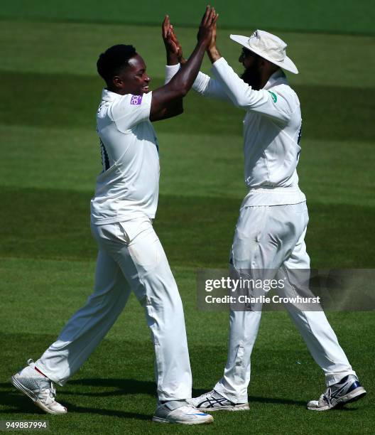 Hampshire's Fidel Edwards celebrates with Hashim Amla after bowling out Surrey's Ben Foakes during day three of the Specsavers County Championship...