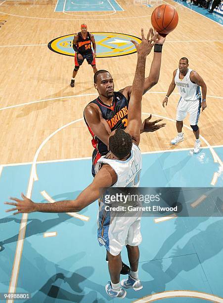 Chris Hunter of the Golden State Warriors puts up a shot against Malik Allen of the Denver Nuggets during the game on December 1, 2009 at the Pepsi...