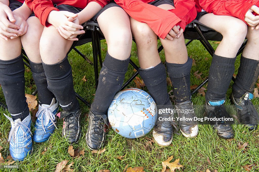 Girls' Soccer Team on bench with soccer ball