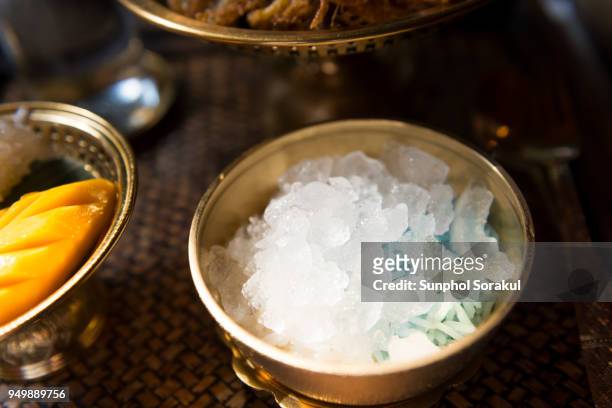 a bowl of rice in ice for traditional thai food khao chae - sunphol stock pictures, royalty-free photos & images