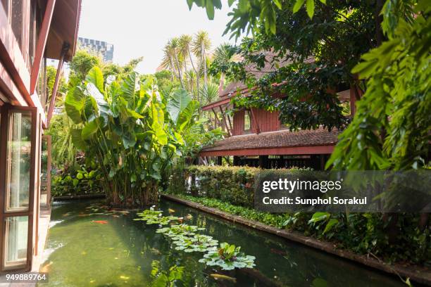 thai garden with pond and traditional wooden house - sunphol stock pictures, royalty-free photos & images