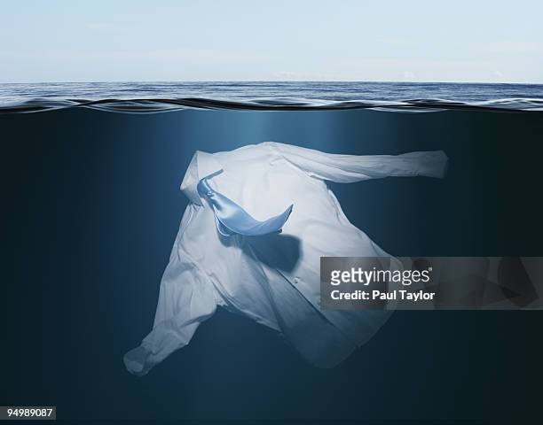 shirt and tie floating underwater - underwater composite image stock pictures, royalty-free photos & images