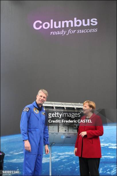 With Columbus laboratory in the background, Chancellor Angela Merkel with astronaut Thomas Reiter, 48 years old, the first European who will spend 6...