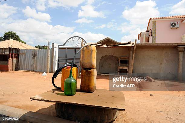 Containers of blackmarket fuel are pictured in a street in Luanda, on December 21, 2009. Drivers come at a rate of 1,500 a day, pumping 65,000 litres...