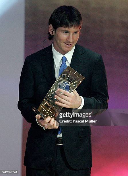 Argentina's Lionel Messi receives the 2009 FIFA World Player Trophy from UEFA President Michel Platini and FIFA President Sepp Blatter during the...