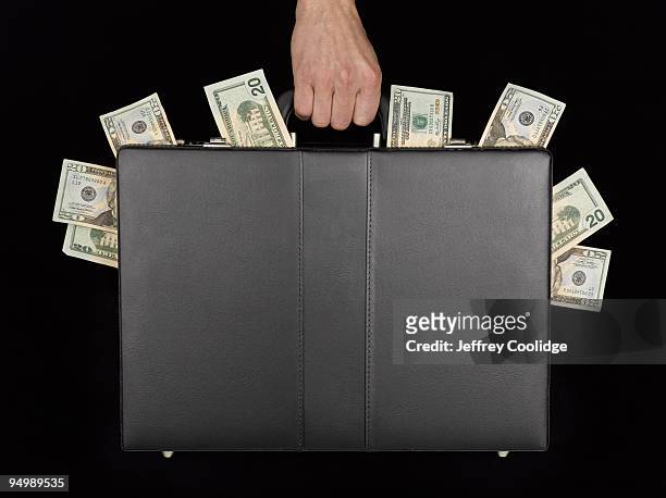 briefcase with money - money laundering fotografías e imágenes de stock