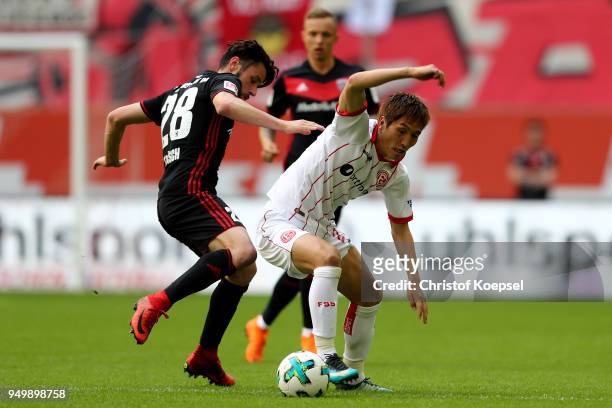 Christian Traesch of Ingolstadt challenges Genki Haraguchi of Duesseldorf during the Second Bundesliga match between Fortuna Duesseldorf and FC...