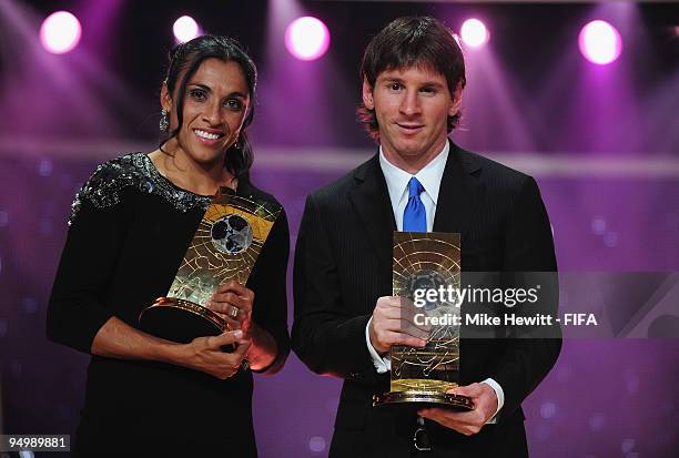 Marta of Brazil holds aloft the FIFA Women's Player of the Year award and and Lionel Messi of Barcelona and Argentina holds aloft the FIFA Men's...