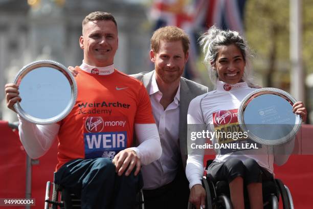 Britain's Prince Harry poses with the elite men's and women's wheelchair winners Britain's David Weir and Australia's Madison de Rozario at the 2018...