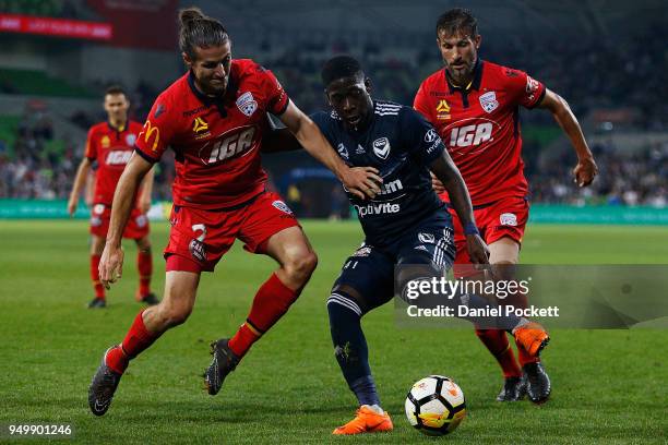 Leroy George of the Victory contests th ball with Michael Marrone of Adelaide United and Vince Lia of Adelaide United during the A-League Elimination...