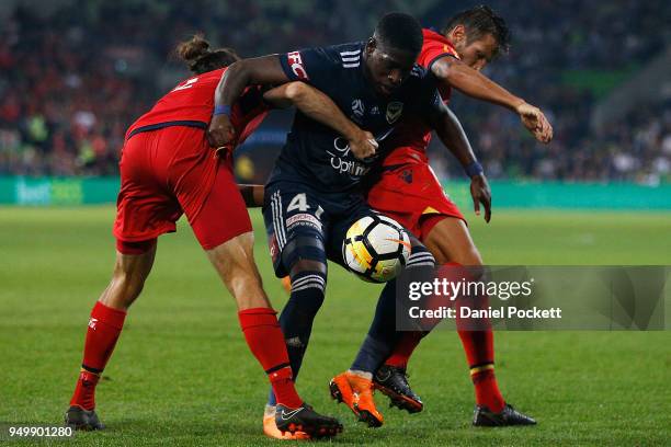 Leroy George of the Victory contests th ball with Michael Marrone of Adelaide United and Vince Lia of Adelaide United during the A-League Elimination...