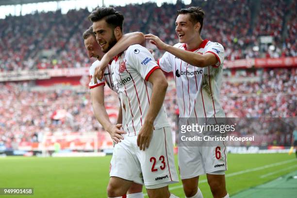 Niko Giesselmann of Duesseldorf celebrates the second goal with Julian Schauerte and Florian Neuhaus during the Second Bundesliga match between...