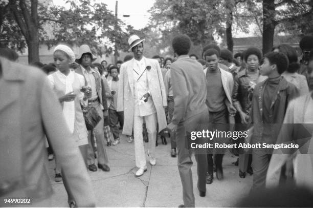 Well-dressed senior member of the Omega Psi Phi fraternity, parades down the grounds of Fisk University as part of fraternity pledges' initiation...